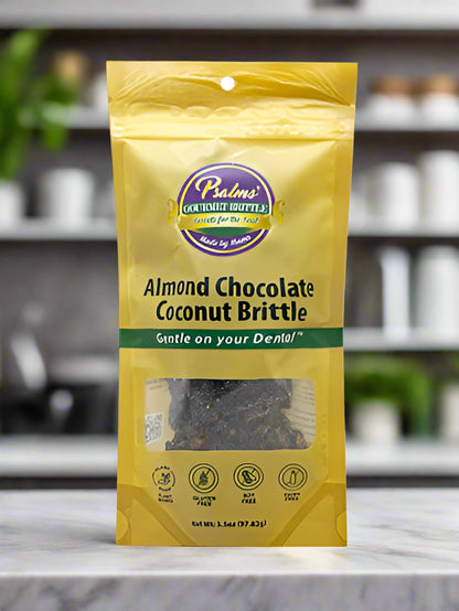 Handcrafted Almond Chocolate Coconut Brittle featuring golden-brown candy studded with premium almonds, dark chocolate drizzle, and toasted coconut flakes